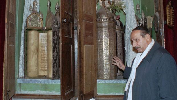 Youssef Jajati, a Jewish community leader, shows the Torah holy book in Jobar Synagogue which dates back to 718 BC.jpg
